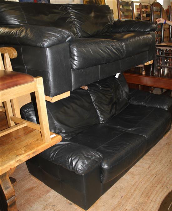 Pair of black leather 2 seater sofas